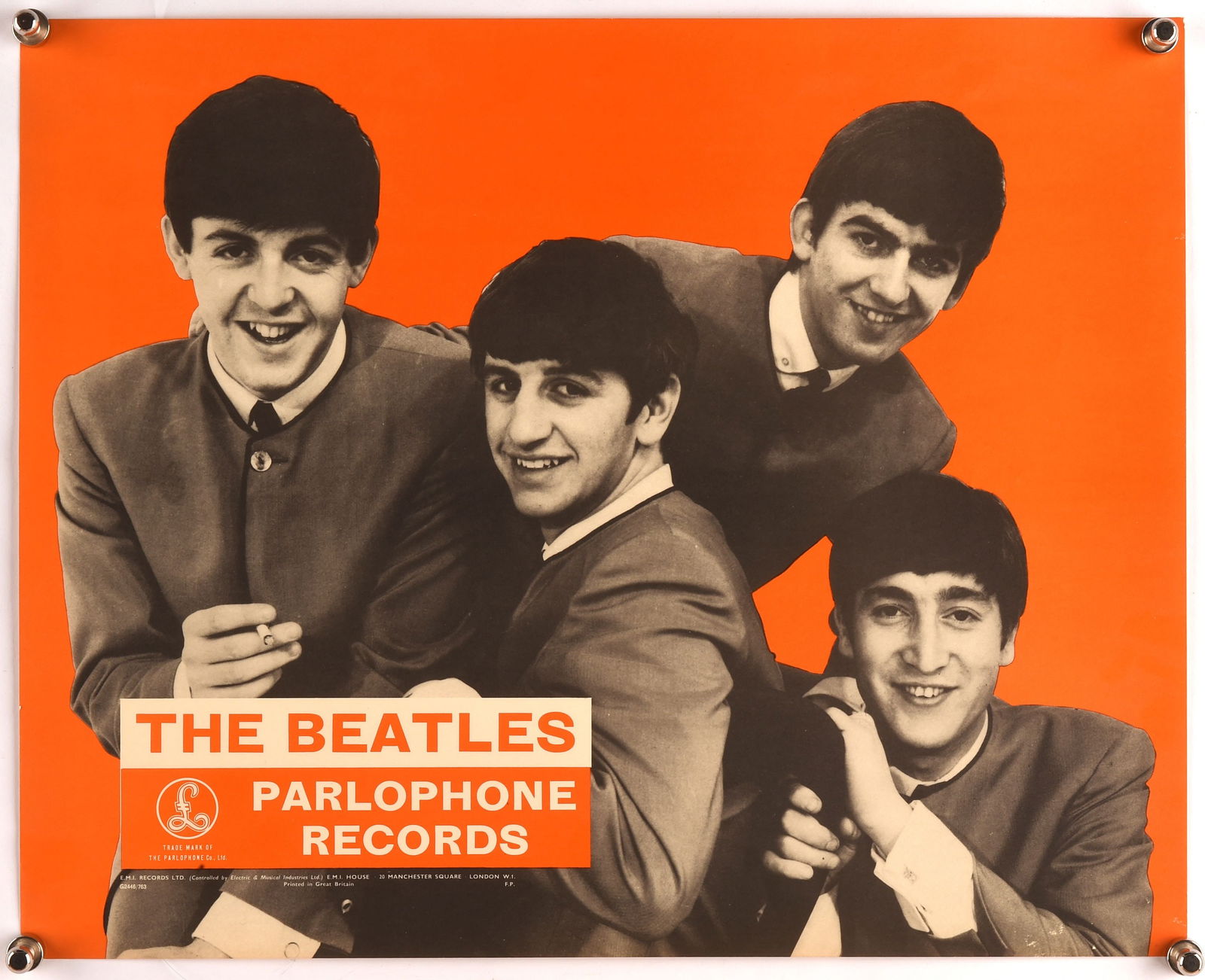 The Beatles. Parlophone Records promotional poster: The Beatles. Parlophone Records promotional poster. EMI Records, 1963. Black and white image of The Beatles on vibrant orange background, rare Beatles poster. 30.4 x 37.8 cm. Rolled.