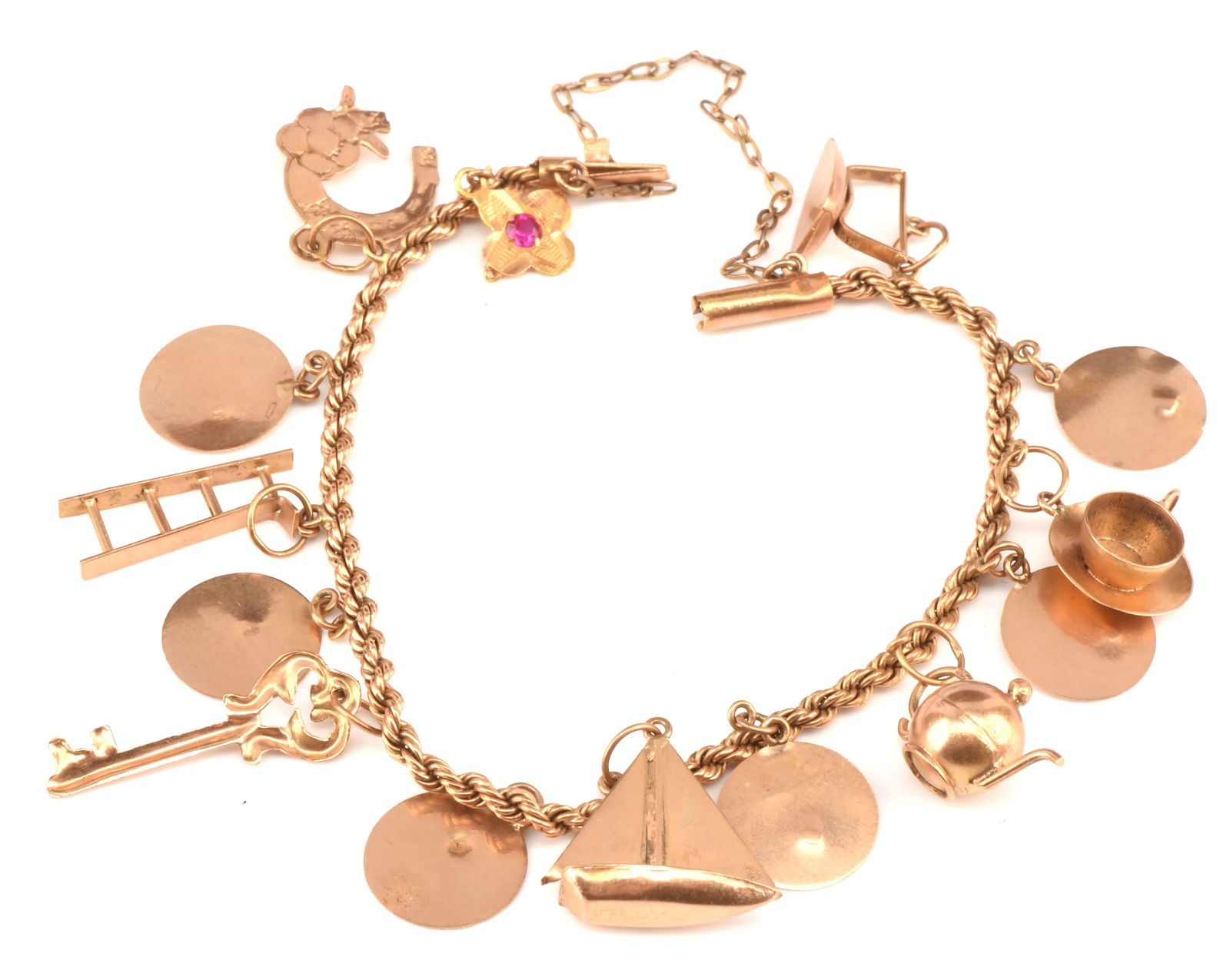 Egyptian gold charm bracelet, with twisted rope br: Egyptian gold charm bracelet, with twisted rope bracelet and tube lock clasp and 14 charms, including a tea cup, horse shoe, sailing boat, ladder and others, baring Egyptian marks for 18 ct Gross weig