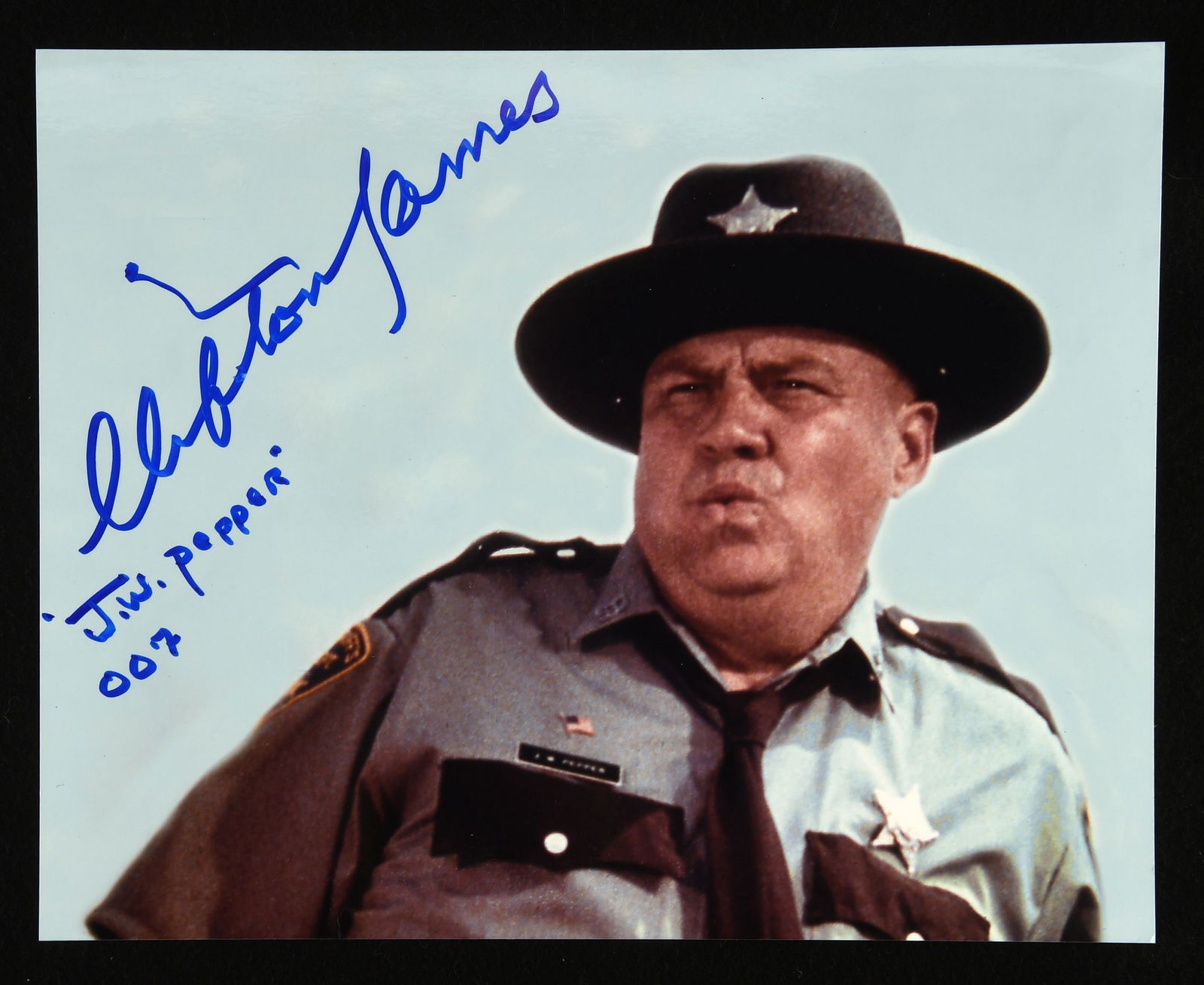 James Bond 007: Clifton James (1920-2017) colour p: James Bond 007: Clifton James (1920-2017) colour photograph -depicted as Sherriff J.W. Pepper in Live and Let Die (1973) Signed in blue marker pen by the American actor who also starred in Cool Hand L