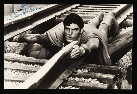 Christopher Reeve (1952-2004) black and white publ: Christopher Reeve (1952-2004) black and white publicity photograph, depicted as Superman showcasing his strength and heroism in the scene where he bends the rail of a railway track in Superman (1978)