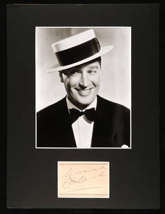 Maurice Chevalier (1888-1972) Autograph display –: Maurice Chevalier (1888-1972) Autograph display &#8211; black and white publicity photograph -depicted wearing his trademark boater hat and tuxedo, the image 7 &#189; x 9 &#189; inches within black ca