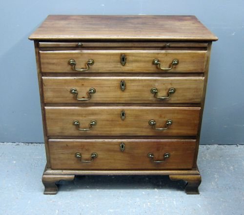 George III mahogany chest of brushing slide above four