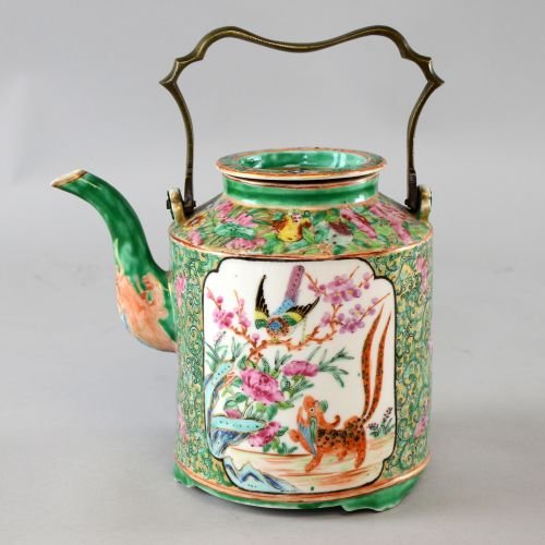 Canton famille rose tea pot and cover, with two panels: Canton famille rose tea pot and cover, with two panels of mythical beasts and flowers and foliage, with cast bronze handle, on three feet, 8½in. (20cm)