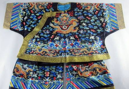 Chinese silk robe , with extensive embroidery worked in: Chinese silk robe , with extensive embroidery worked in silk stitch depicting dragons with flaming pearls , storks and bats another dragon panel and border of brocaded gilt fabric , offset fastening w