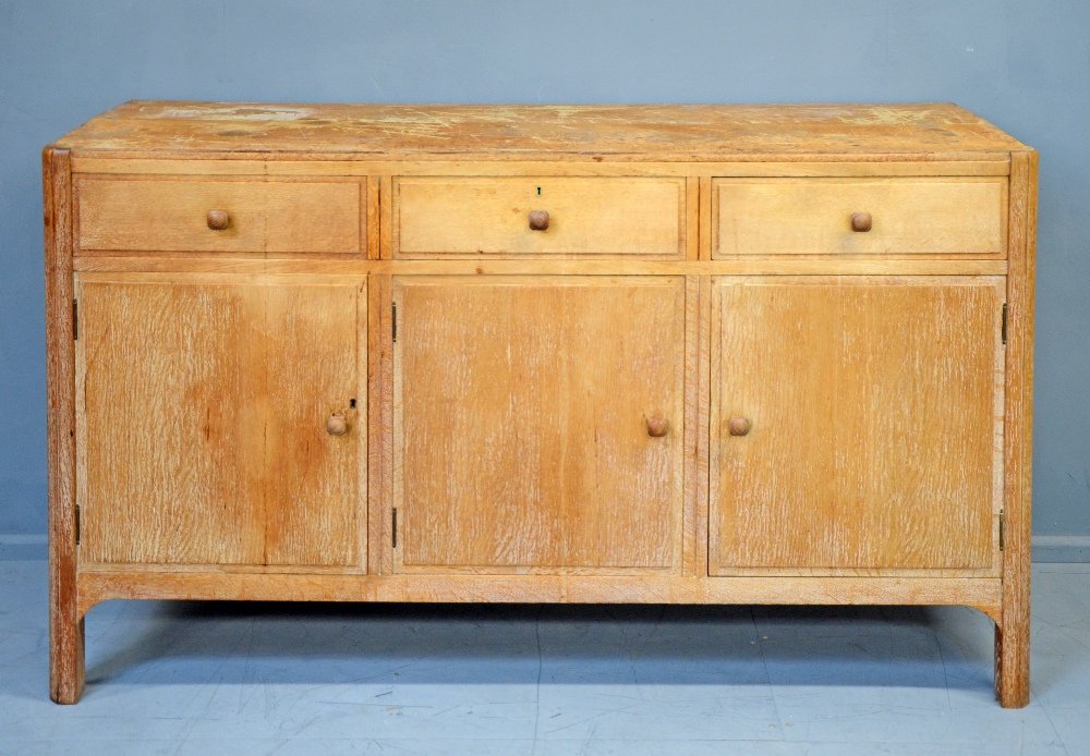 Heals of London limed oak sidebaord in the Cotswold: Heals of London limed oak sidebaord in the Cotswold School manner three drawers and three cupboard doors on square legs 31in. (79cm)