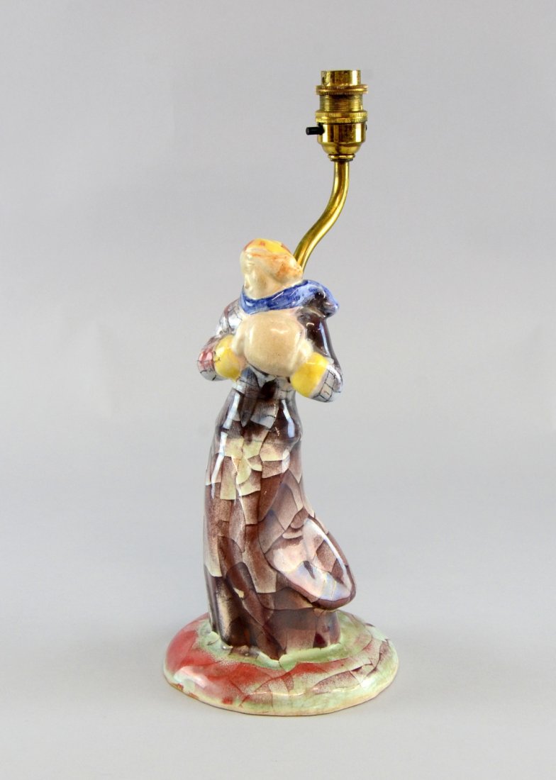 Michael Andersen Denmark pottery figural lamp base: Michael Andersen Denmark pottery figural lamp base Figure of a girl in winter clothes, relief, stamped marks and paper label 14in. (36cm)