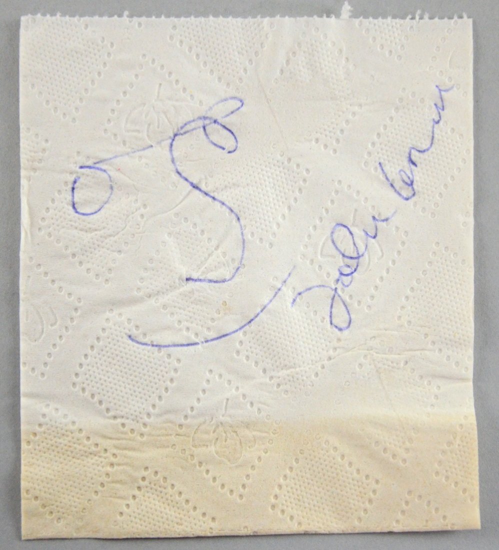 John Lennon, The Beatles, a piece of tissue signed in: John Lennon, The Beatles, a piece of tissue signed in blue biro with a sketch of a face in typical Lennon fashion Provenance: This was purchased in the 1990's from a gentleman who met Lennon at a Moto