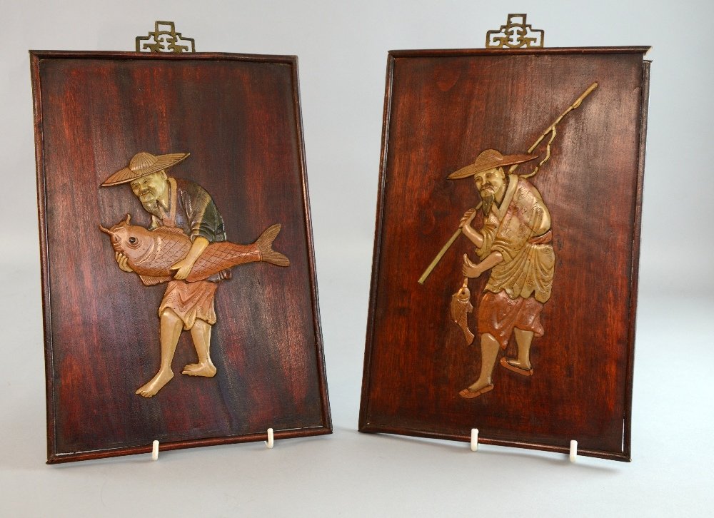 Two Chinese hardwood wall panels each decorated with: Two Chinese hardwood wall panels each decorated with fishermen in coloured soapstone, 12½ x 8½in. (30 x 20cm)
