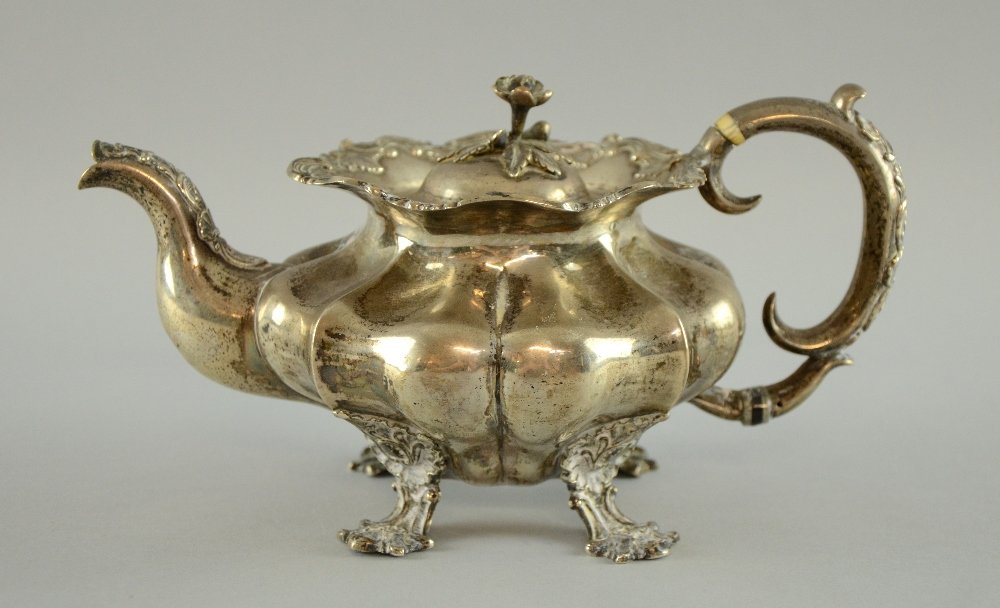 19th century Russian silver tea pot of serpentine form: 19th century Russian silver tea pot of serpentine form with scroll decoration on four feet, by Gustav Magnus Akerblom, St. Petersburg, 1844, 26oz gross weight,