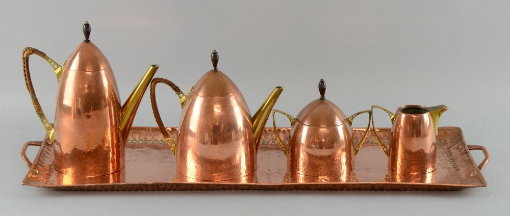 Early 20th C copper and brass tea and coffee set of: Early 20th C copper and brass tea and coffee set of rounded conical form and a John Pearson hammered copper tray the tea and coffee pot with cane covered handle and turned finial , stamped marks, two