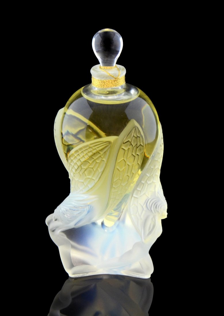 Lalique scent bottle 'Les Elfes' flacon collection 2002: Lalique scent bottle 'Les Elfes' flacon collection 2002 , 75 ml perfume, sealed, boxed signed and numbered ovoid clear glass bottle with three opalescent fairies , 16 cm