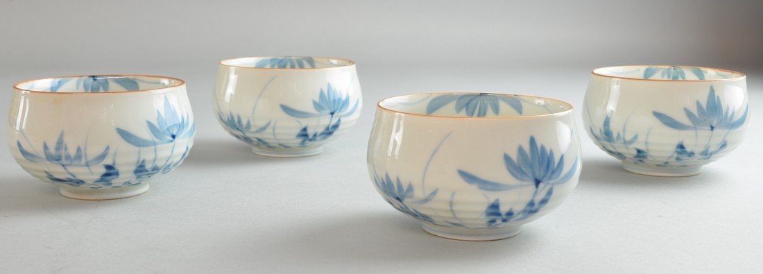 Set of four Japanese blue and white tea bowls with: Set of four Japanese blue and white tea bowls with floral decoration, marks to bases,