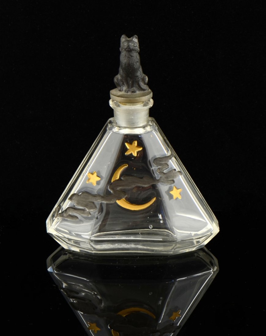Art Deco glass perfume bottle by Julien Viard, the: Art Deco glass perfume bottle by Julien Viard, the stopper in the form of a cat , faceted glass with enamelled decoration of stars and the moon in clouds, produced for Depinoix , unmarked, 11 cm