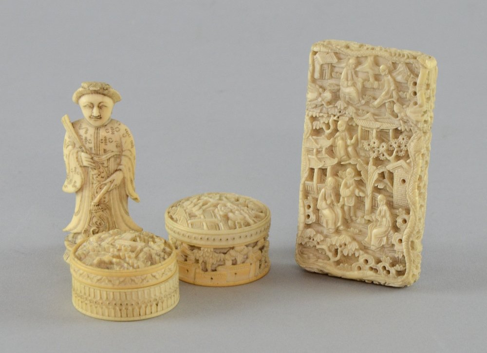Chinese ivory card case carved in relief with figures: Chinese ivory card case carved in relief with figures in gardens, 8.5cm high, two carved ivory counter holders and a chess piece,