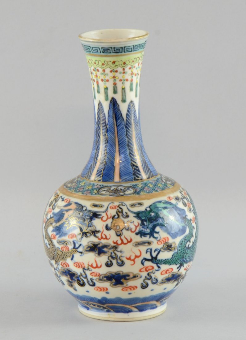 Chinese porcelain vase decorated in colours with two: Chinese porcelain vase decorated in colours with two dragons chasing a flaming pearl above an ocean, four character mark to base, 21.5cm high,