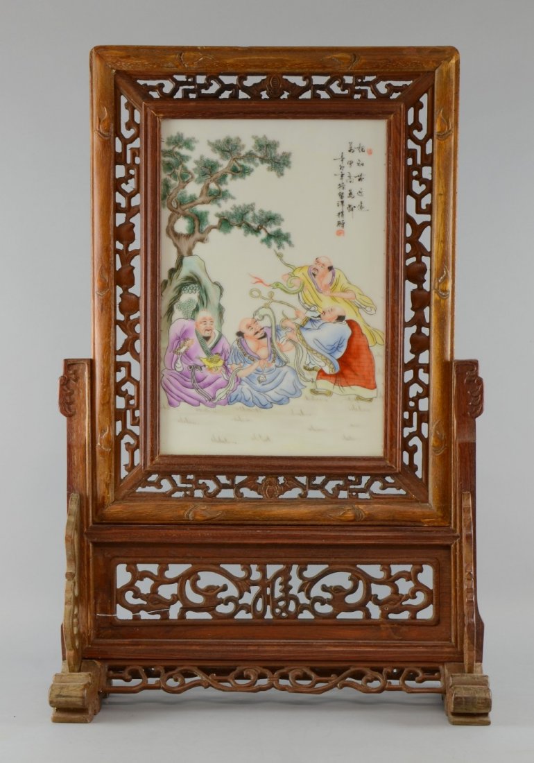 A similar Chinese porcelain screen decorated with four: A similar Chinese porcelain screen decorated with four Sages under a tree mounted as a table screen in wooden frame 24cms x 35cms