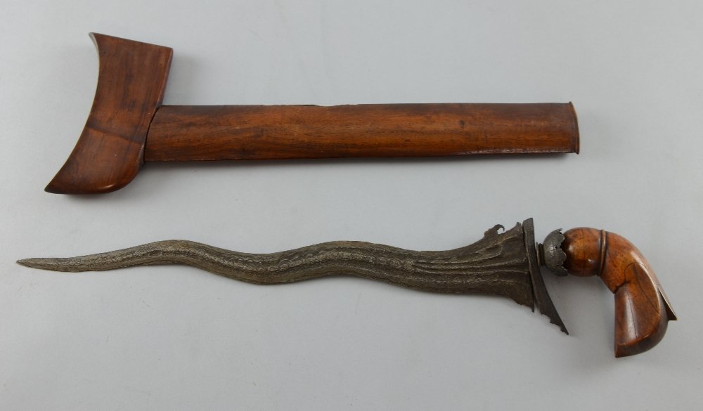 Malaysian 'Kris' dagger with wavy layered blade, carved: Malaysian 'Kris' dagger with wavy layered blade, carved wooden handle and sheath, 44.5cm long, Blade very worn. Handle loose, chipped and comes off. Sheath chipped and split. Overall very worn.