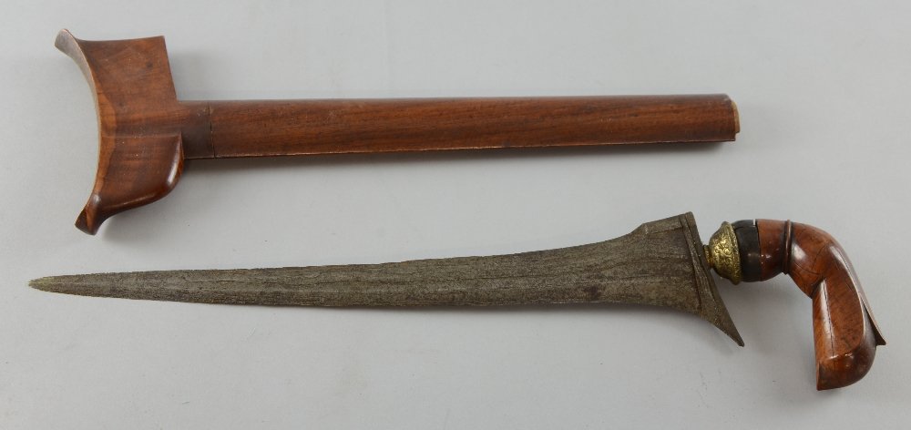 Malaysian 'Kris' dagger with wavy layered blade, carved: Malaysian 'Kris' dagger with wavy layered blade, carved wooden handle and sheath, 46cm long, Blade very worn. Handle loose, chipped and comes off. Chip and wear to sheath and sheath missing end mount.