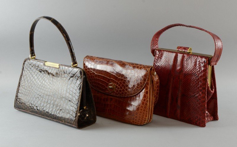 Three Vintage crocodile and snake skin handbags, a mid: Three Vintage crocodile and snake skin handbags, a mid brown 1930's crocodile skin bag, dark brown crocodile bag, 1960's and a red snakeskin bag with matching purse