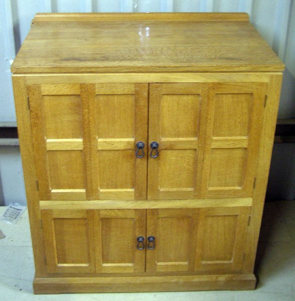 Robert Mouseman Thompson oak panelled television ca: Robert Mouseman Thompson oak panelled television cabinet 34" wide (Illustrated)