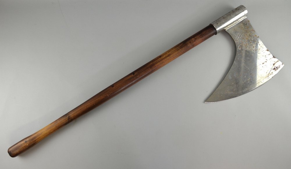 A prop axe, from an unknown production, with shaped: A prop axe, from an unknown production, with shaped wooden handle and etched steel head, length 107.5cmProvenance: From the Estate of Sir Christopher Lee