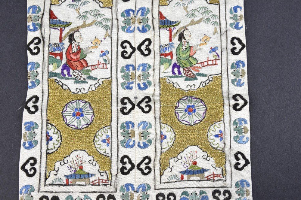 A pair of Chinese sleeve panels, profusely decorated in (1 of 2)