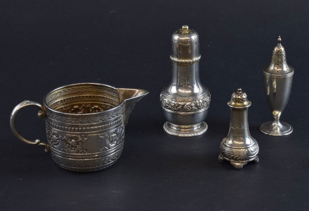 Victorian silver jug, decorated with bands of natural: Victorian silver jug, decorated with bands of natural and scientific motifs, London 1886, makers Charles Stuart Harris, along with three pepperettes, total silver weight 213g/ 6.86ozt, (4),