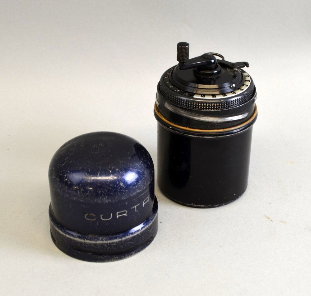 A Curta Calculator Type II numbered 517106, marked to (1 of 5)