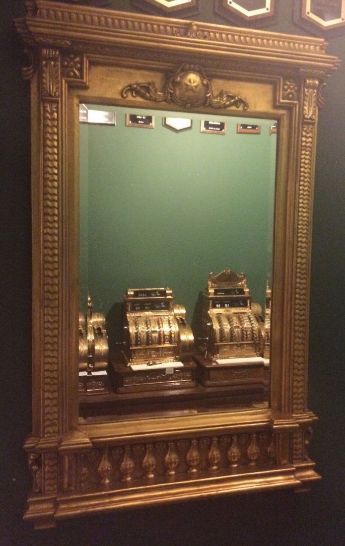 Heavily Gilt Antique Mirror: Beautiful giltwood mirror with late Victorian motifs and a spindled base