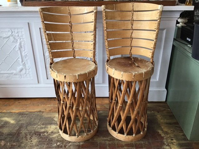 VINTAGE CEDAR STRAP EQUIPALE BAR STOOLS: CEDAR STRAPPED PAIR OF EQUIPALE BAR STOOLS WITH ANIMAL HIDE SEATS. STOOLS ARE 26 INCHES TALL TO SEAT, 43 3/4 TALL TO BACK, SEATS ARE 15 X 15 EACH. SOLID AD STURDY.