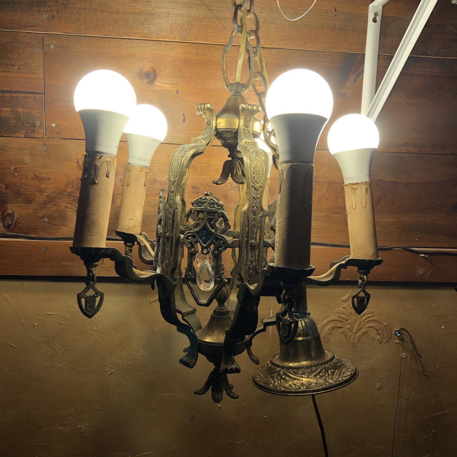 Art Deco Ornate Metal & Prism Chandelier: brass with painted shield and prisms, 16 inches long & 14 in diameter with out chain