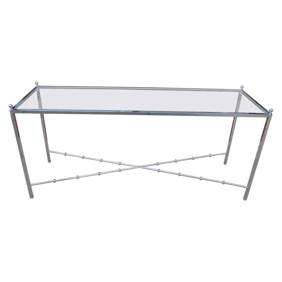 Chrome and Glass Console Table: Wear consistent with age and use. Insignificant chip to a corner of the glass. Chrome in excellent condition.Height: 26 in. (66.04 cm)Width: 19 in. (48.26 cm)Depth: 60 in. (152.4 cm)