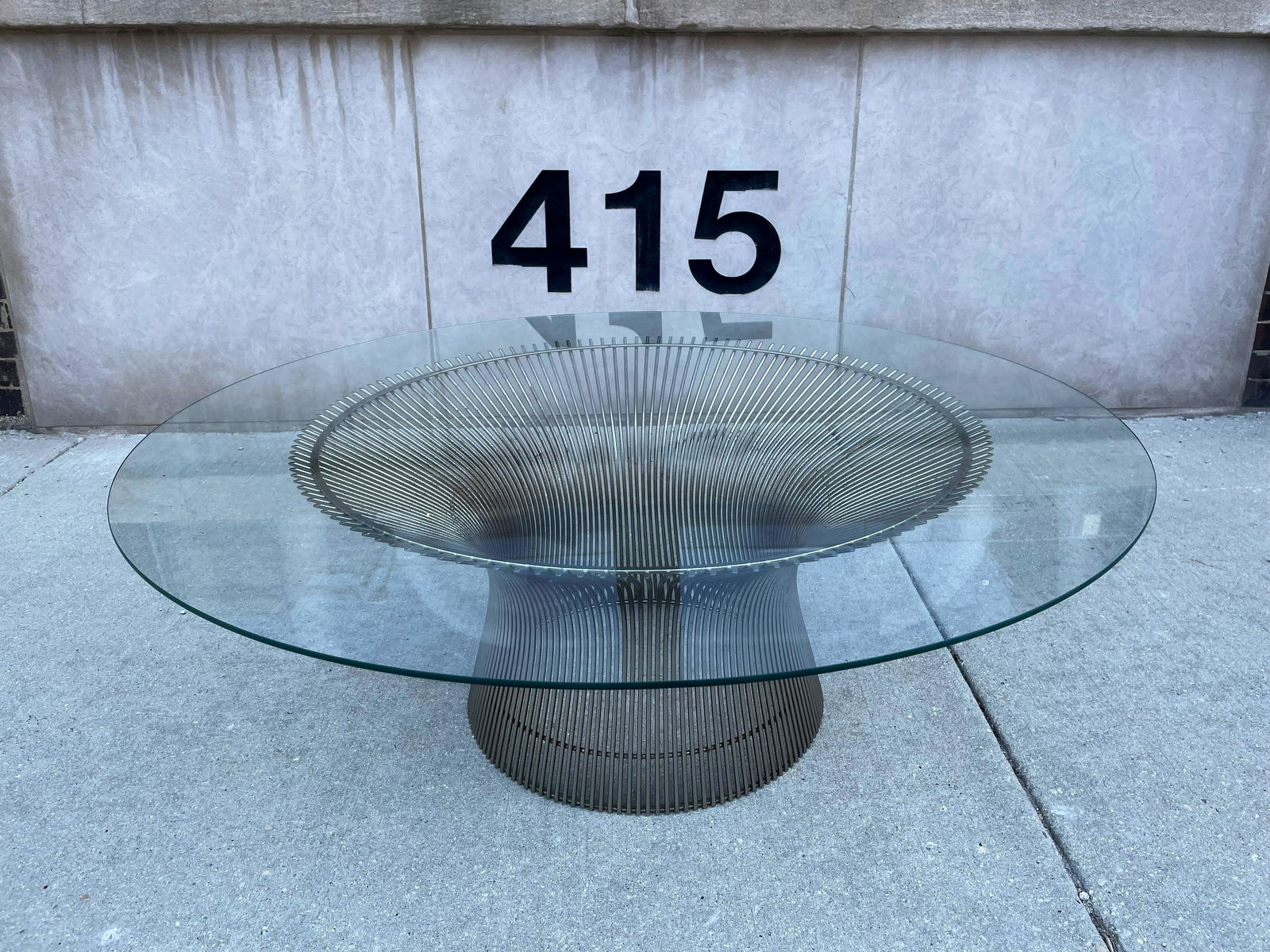 Mid Century WARREN PLATNER for KNOLL Glass and Stainless Steel Coffee Table: Glass top measures 42in DIA, the base measures 29.5in DIA x 14in H
