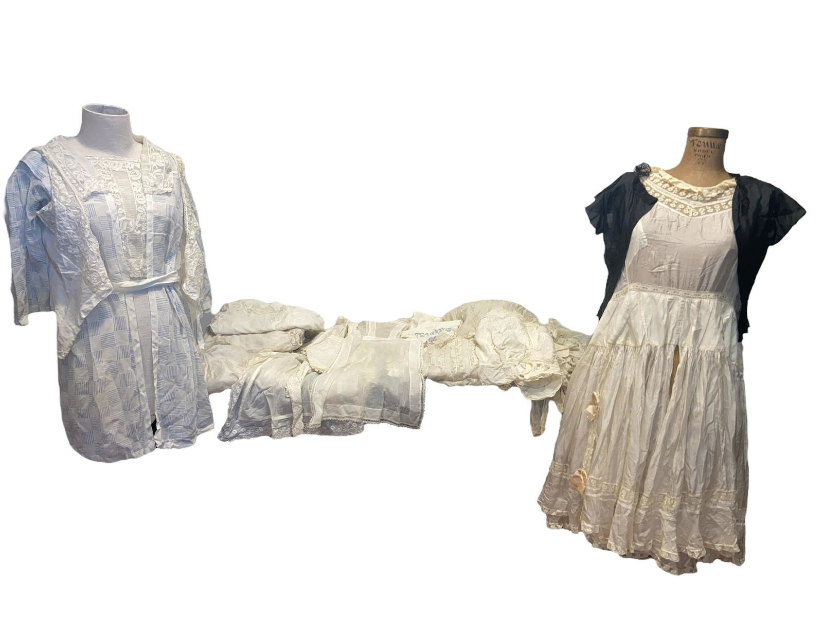 Collection Vintage Edwardian Womens Lace Articles Apron Nightgown: all pieces range in size. In this lot, there are 4 nightgowns or dresses, 5 aprons, 13 tops, 3 doll clothing items, 1 large tablecloth, and 4 miscellaneous table runners/ kitchen towels.