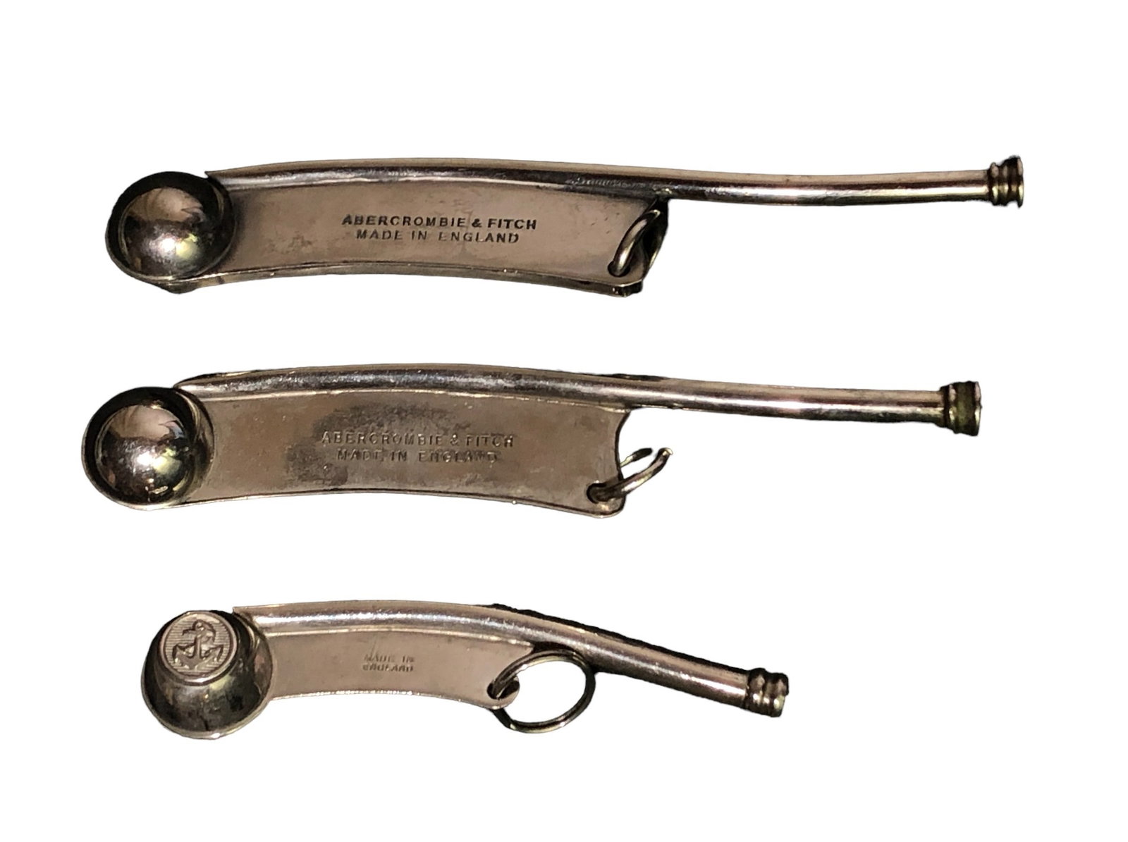 (3) Antique Yachting Whistles, ABERCROMBIE & FITCH: Two are Abercrombie & Fitch and measure 1" H x .75" W x 5.25" D, the third measures 3.75" W x 1"D