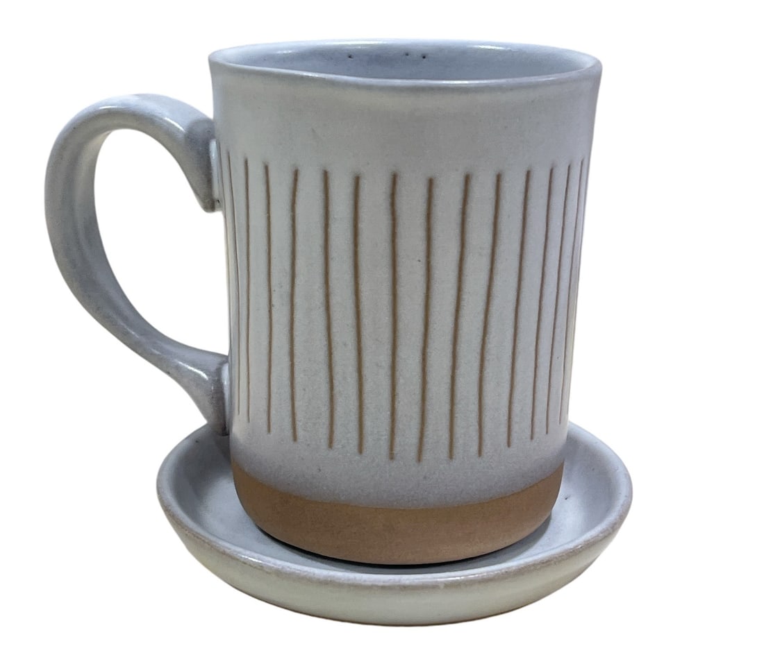 A Mid Century MARTZ MARSHALL STUDIOS Coffee Mug and Saucer: Mug measures 4" H x 4.5" W, saucer has 4" DIA. The mug retains a Martz signature on the bottom.