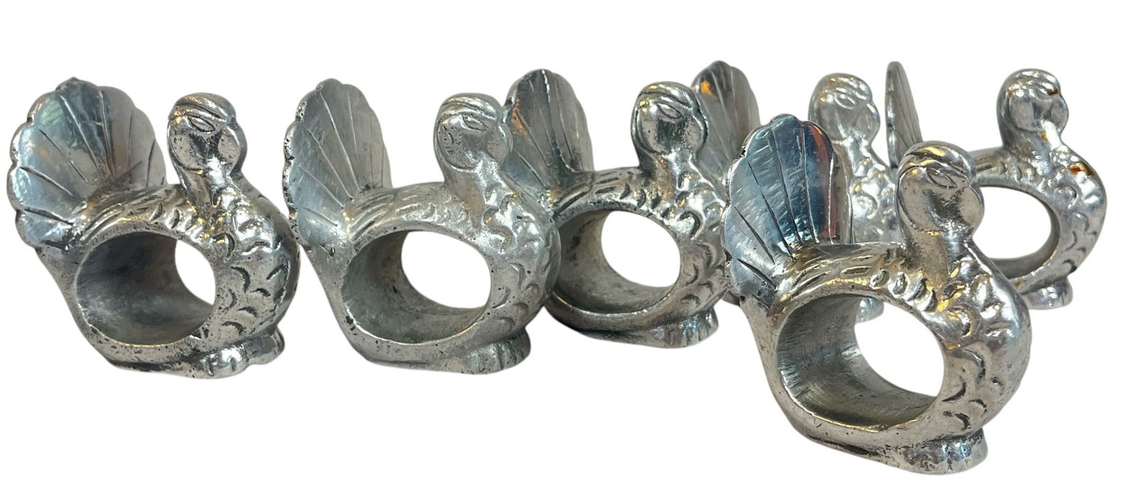 Six Silver Turkey Napkin Ring Holders: Each measure 2.5" H x 1.75" W x 2" D. These are a silver toned metal but are not sterling silver.