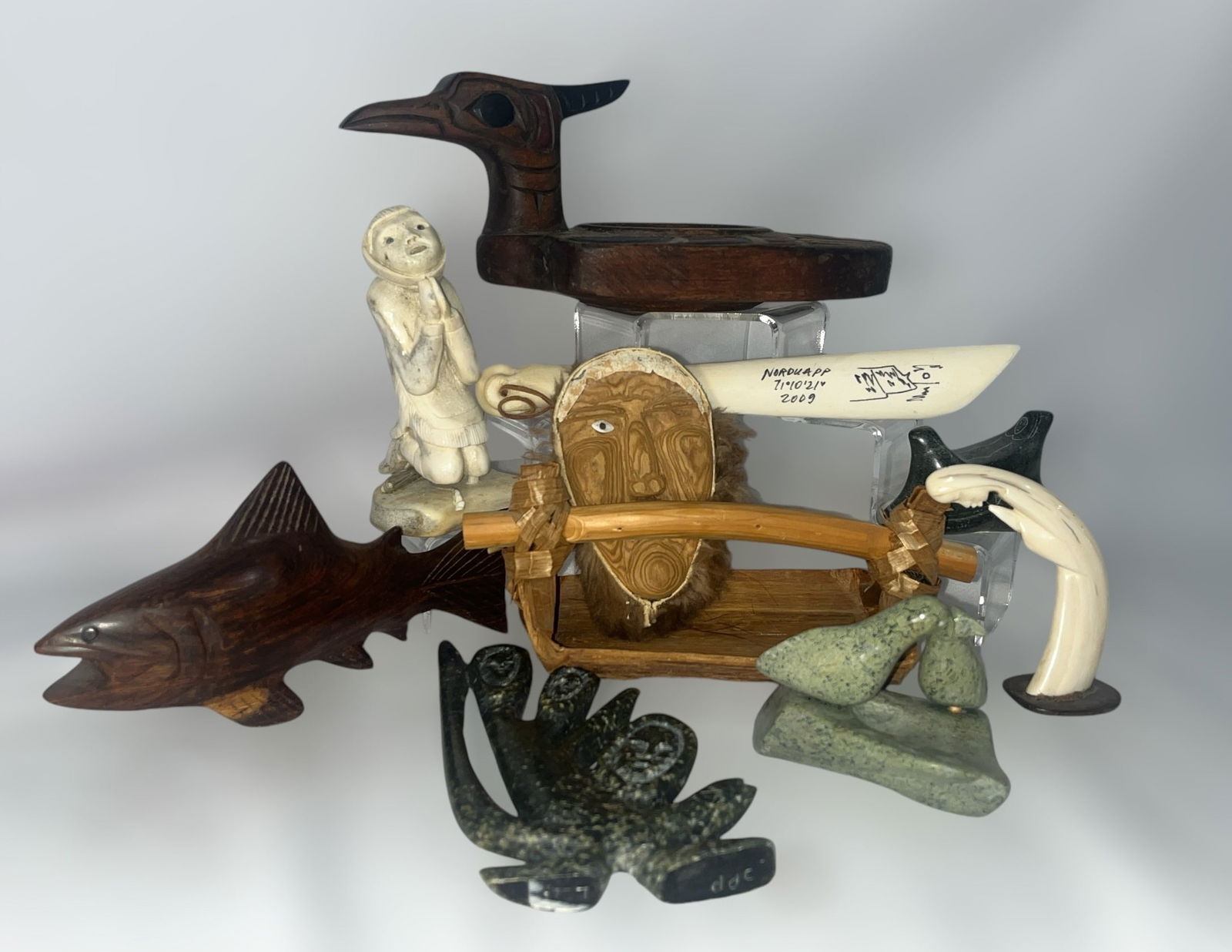 Collection of Northwest Coast and Inuit Articles: Includes a Northwest Coast Loon Bowl by artist Robert Cecil that measures 4" H x 5" W x 9.5" D and other assorted carved stone, bone articles.