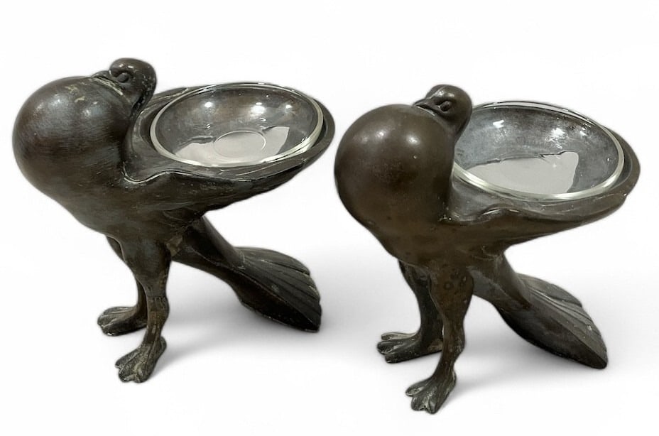 A Pair of Art Deco FRANKART Bird Ashtrays: Made out of a cast metal. Both measure 6" H x 4.5" W x 6" D.