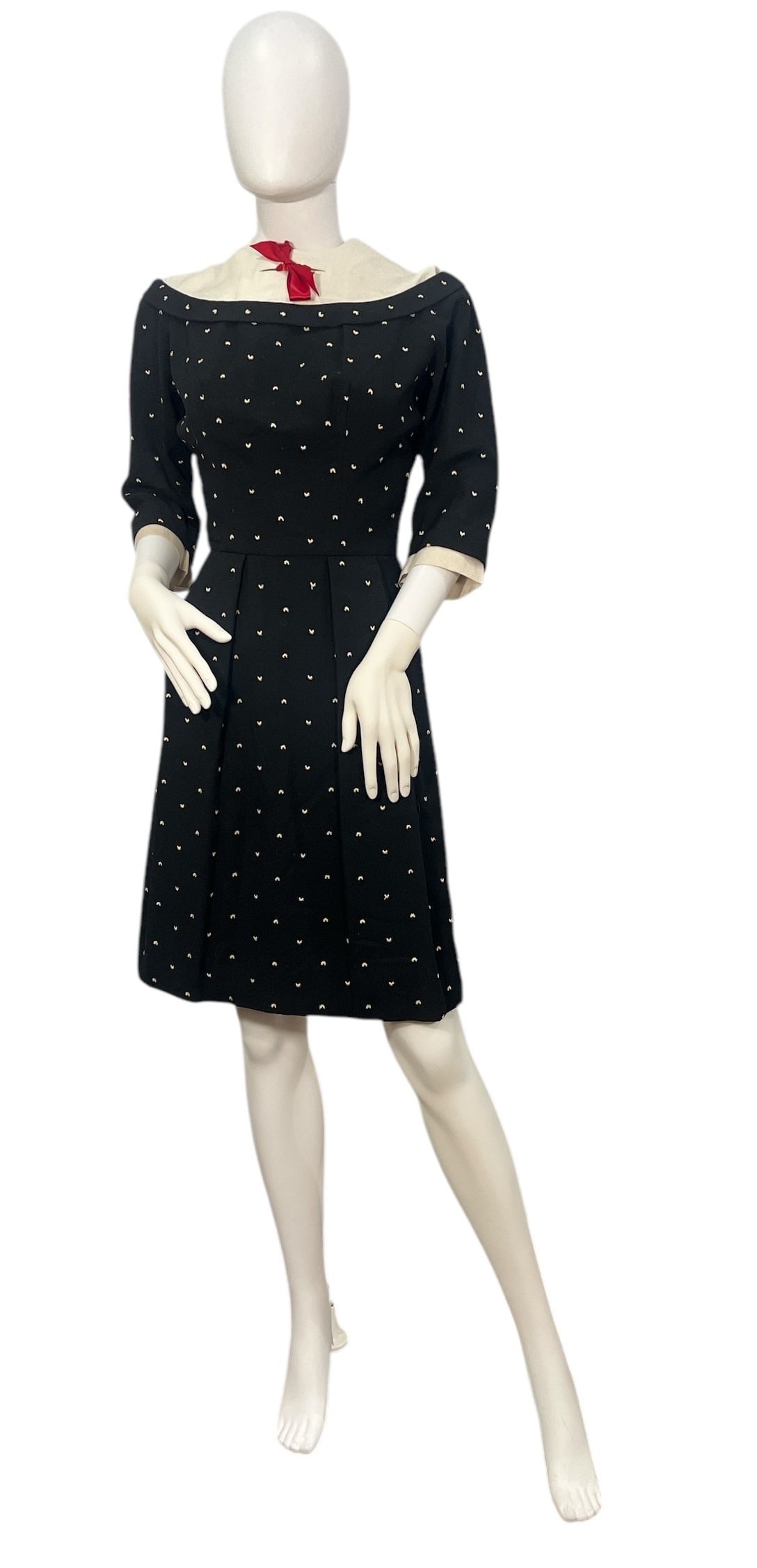Vintage 1950's Black and White Polka Dot Day Dress: The label reads; Florence Hubbard Woods, Ill. The dress has a total length of 16" from nape of neck to waist, 8.5" from under arm to waist and 22"L from waist. The bust is 36" and the waist is 24". Sl