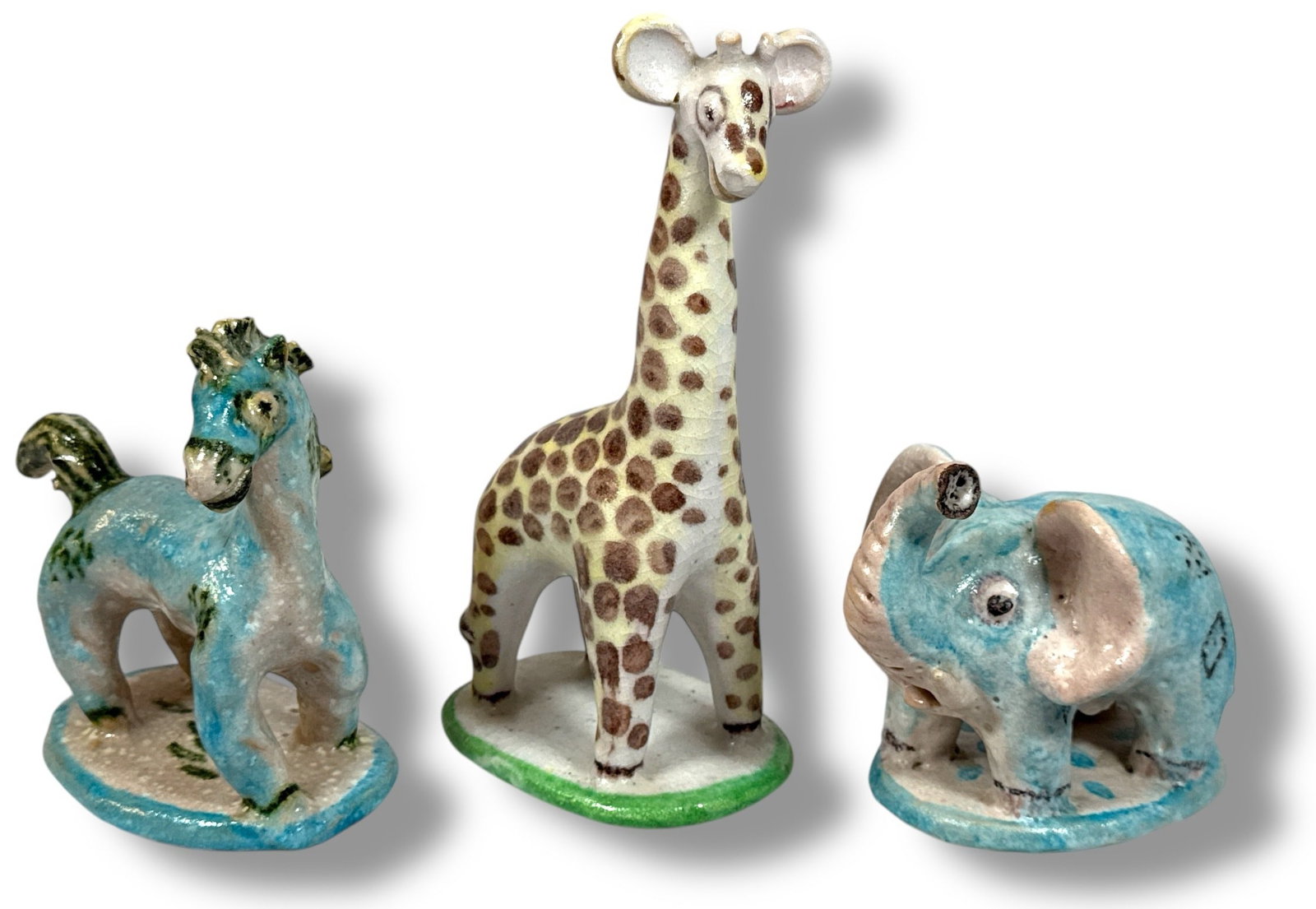 GUIDO GAMBONE, Three Ceramic Animal Sculptures: Italy, Circa 1950's. Guido Gambone signature and donkey mark to underside. Giraffe measures 9.5" H x 3.75" W x 4.75" D. Horse measures 6" H x 3.75" W x 6" D. Elephant measures 5" H x 3.5" W x 6" D.