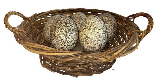 A Woven Wicker Basket with Faux Ostrich Eggs