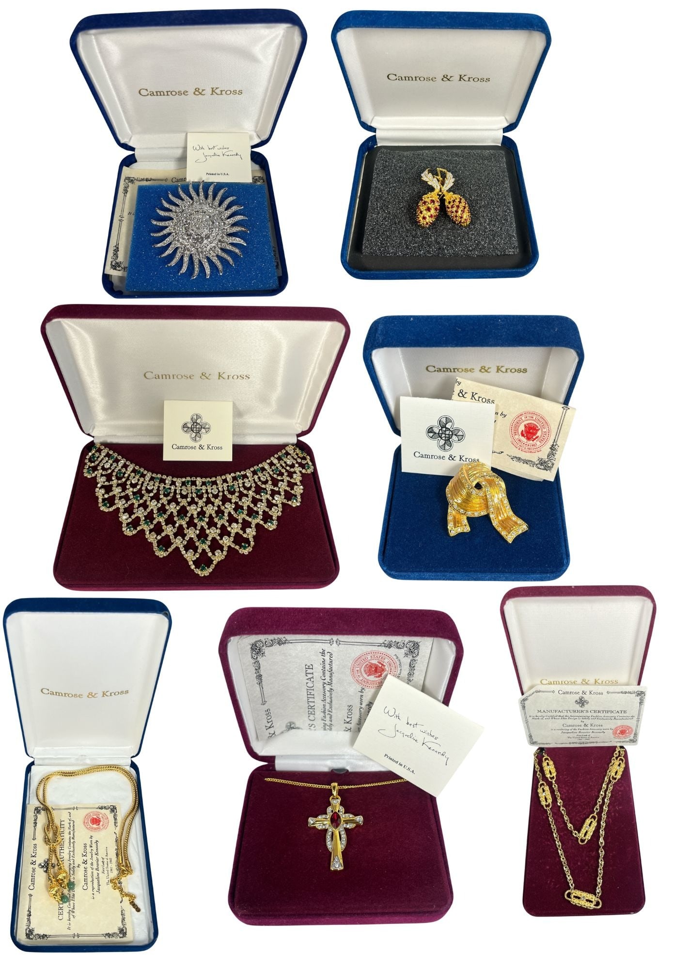 Collection of CAMROSE & KROSS Jacqueline Kennedy Jewelry: Includes variety of reproduction jewelry worn by Jacqueline Kennedy ---gold tone ribbon brooch, cross necklace, sunburst brooch, bib necklace, paperclip necklace, berry brooch, and love knot necklace.
