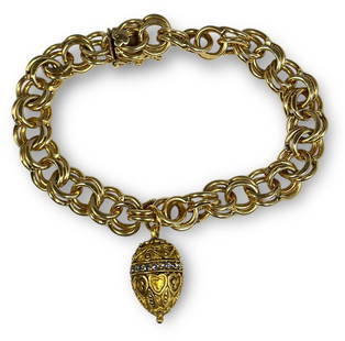 A 14k Gold Double Link Chain Bracelet and 10k Gold Egg Charm: Bracelet itself measures 7" long and the egg pendant measures .5" x .25" DIA. Lot weighs 34.83 grams.