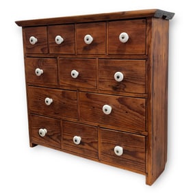 A Primitive Multi Drawer Wall Cabinet