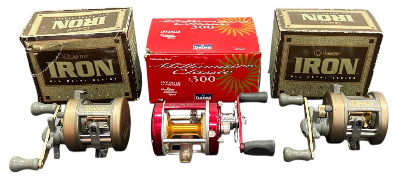 DAIWA, QUANTUM Baitcast Fishing Reels 3 Pcs.: 1 DAIWA Millionaire Classic 300, 2 QUANTUM Iron IR3 DAIWA box measure: 3" H x 6" W x 4" D