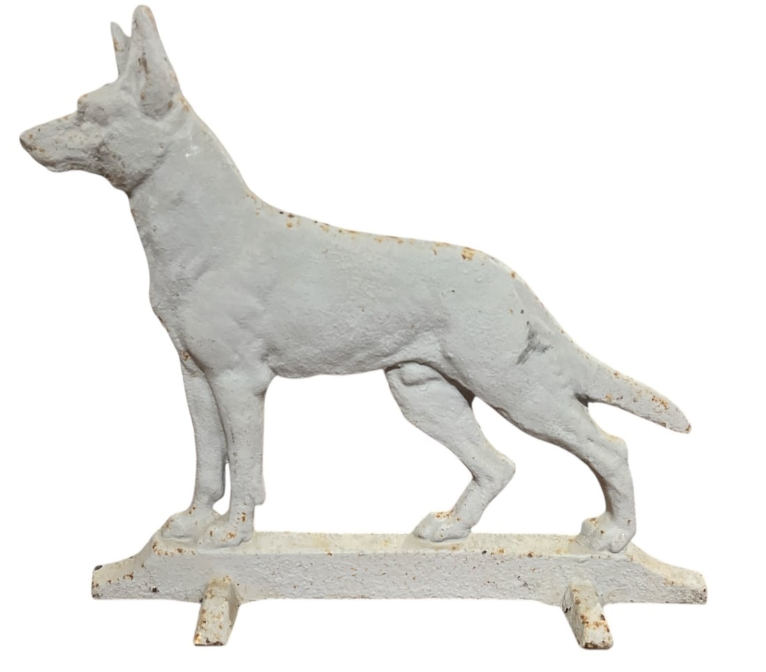A Painted Cast Iron German Shepherd Dog Doorstop: Measures 12.5" H x 14" W x 3.5" D.