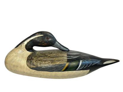 A HENRY PERDEW Sleeping Duck Decoy: Signed on the bottom. Measures 6.25" H x 5" W x 15" D.