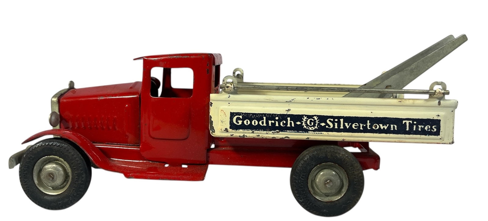 A Vintage METAL KRAFT Goodrich Tires Tow Truck Toy: Measures 5" H x 4" W x 12"D