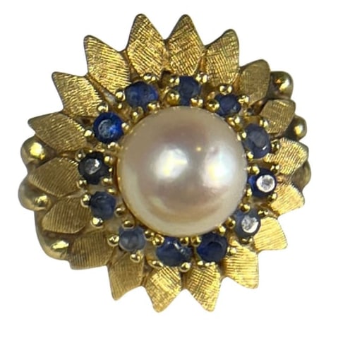 A 14k Gold Sapphire and Pearl Sunflower Ring: 14k yellow gold, sapphire, and pearl size 3 sunflower ring. Center pearl measures approx. 7mm, ring weighs 4.1dwt with stones.